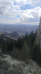Mountain landscape with cross-topped cliff filmed near Smolyan, Bulgaria