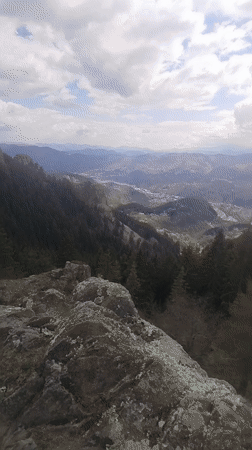 Mountain landscape with cross-topped cliff filmed near Smolyan, Bulgaria