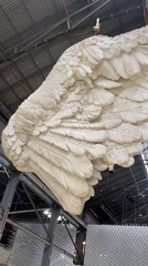 Art installations featuring wing, golden head displayed Buenos Aires venue