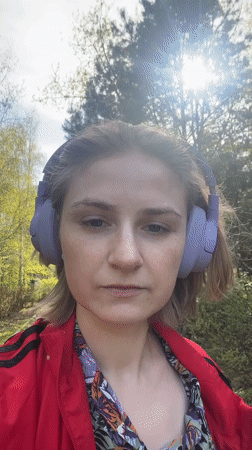 Woman walks corgi through Novosibirsk park during morning outing