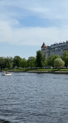White motorboat carries passengers across Saint Petersburg river