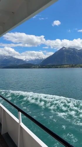 Passenger boat crosses Lake Thun's turquoise waters