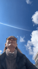 Person takes selfie under blue sky in Kiel