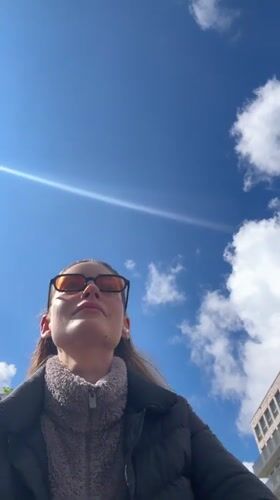 Person takes selfie under blue sky in Kiel