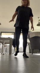 Woman waves hands in French home living area