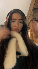 Woman applies makeup and poses in central London