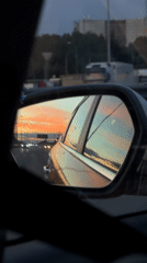Sunset reflected in a side mirror on a Moscow road