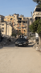 Life continues amid widespread urban damage and rubble