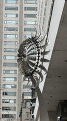 Kinetic sculpture with rotating metallic elements observed in Montreal