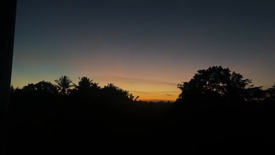Person captures sunset photos in Kediri, Indonesia