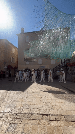 White-uniformed marching band performs in Budva's historic square