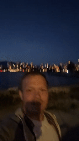 Man films nighttime selfie at Vancouver waterfront