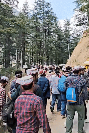 Traditional procession moves through mountainous road near Dunkharamul, India