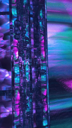 Visitor explores immersive art installation and vintage motorcycle display