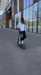 Young man performs scooter tricks on Lyon walkway