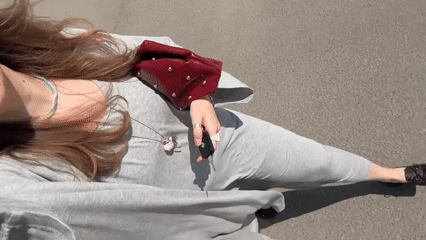 Woman with car keys walks past apartment building in Izhevsk