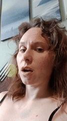 Woman filmed indoors in Yekaterinburg against decorated green wall