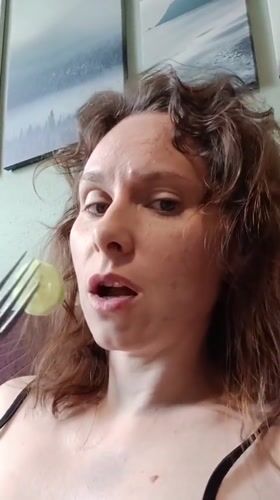 Woman filmed indoors in Yekaterinburg against decorated green wall