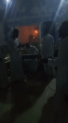White-robed group holds musical worship service in church setting