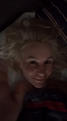 Late-night bedroom moment, waving at the camera