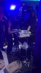 DJ performs at blue-lit Nigeria club with crowd