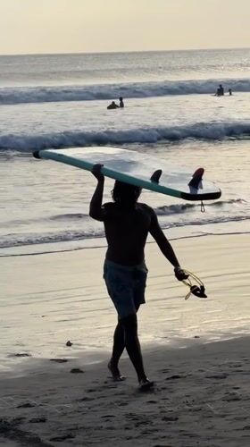 Morning beach life unfolds at Kuta surf destination