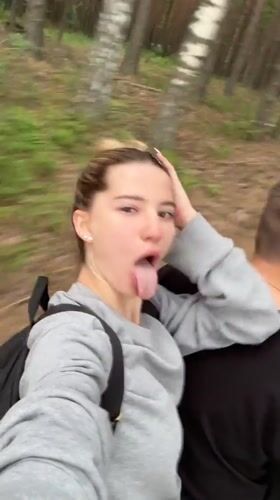 Woman makes faces at camera during forest journey in Russia