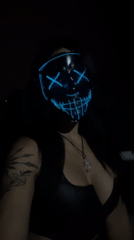 Person in glowing mask documented with cat in Buenos Aires