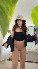 Woman photographed in bedroom setting in Kiryat Bialik