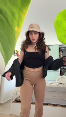 Woman photographed in bedroom setting in Kiryat Bialik