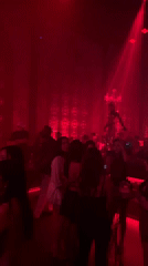 DJ and dancers in chandelier headdresses perform at Bali nightclub