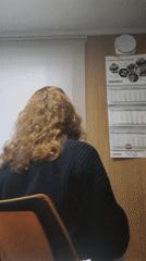 Woman at desk turns to face camera