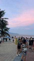 Dusk settles over a busy coastal city promenade