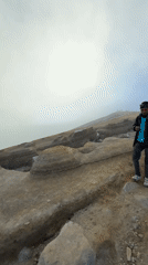 Tourists trek volcanic terrain in Indonesia, encounter sulfur collectors
