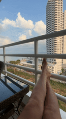 Person relaxes on balcony railing in Pattaya Thailand