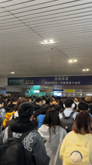 Crowd moves through Chongqing transportation hub during afternoon hours
