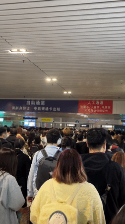 Crowd moves through Chongqing transportation hub during afternoon hours