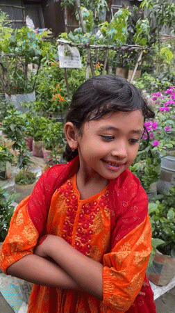 Girl in traditional dress tends garden in Dhaka