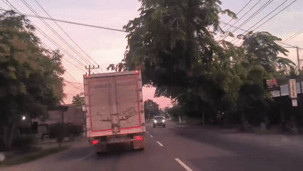 Vehicle follows box truck on road in Cotbadatunong