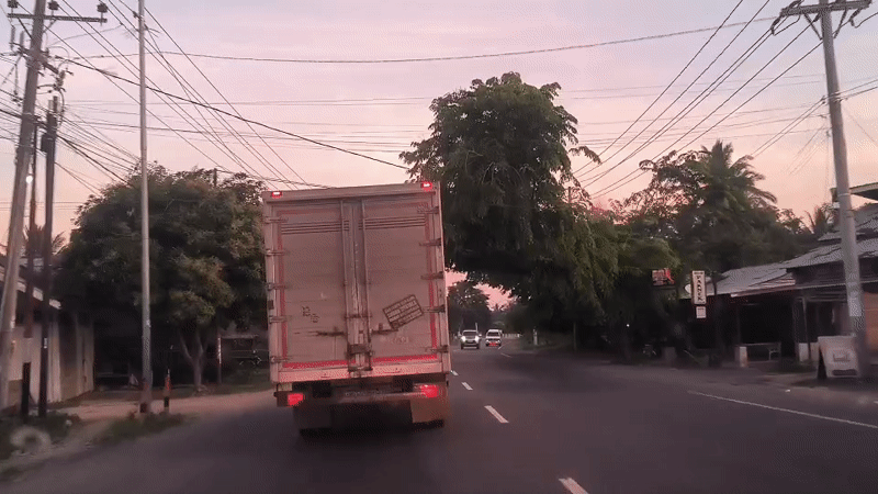 Vehicle follows box truck on road in Cotbadatunong