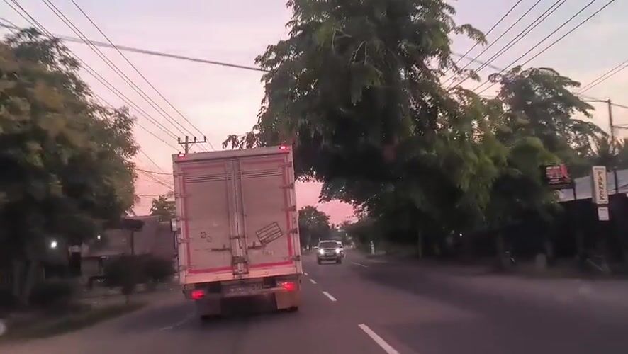 Vehicle follows box truck on road in Cotbadatunong
