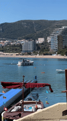Tourist captures Montenegro coastal scenes during seaside café visit
