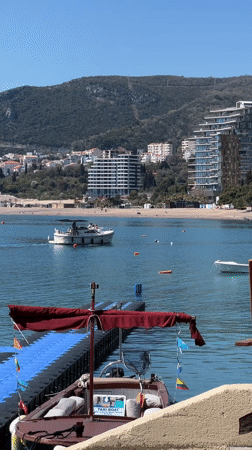 Tourist captures Montenegro coastal scenes during seaside café visit