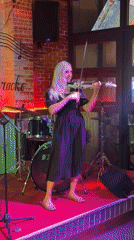Woman performs electric violin on stage in Vietnam