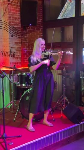 Woman performs electric violin on stage in Vietnam