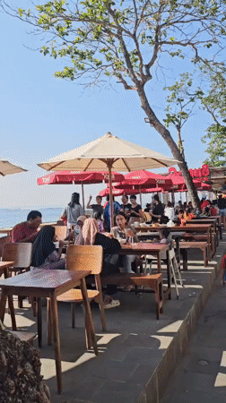 Street life and outdoor dining near Denpasar's busy tourist district