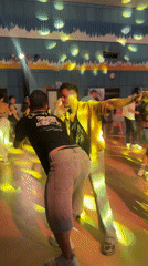 Two men dance together in Pattaya hall