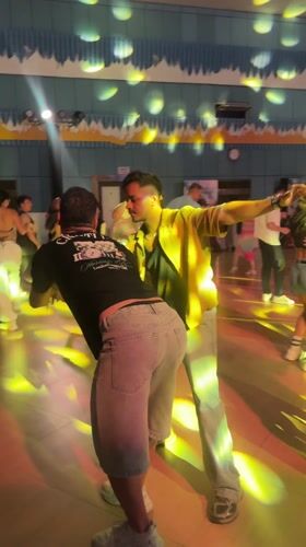 Two men dance together in Pattaya hall