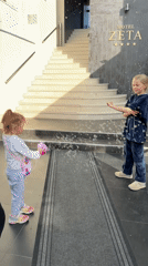 Children play with bubbles near Montenegro hotel, car exits elevator