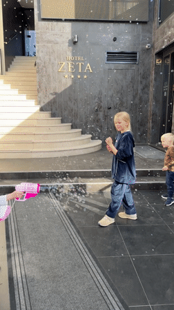 Children play with bubbles near Montenegro hotel, car exits elevator